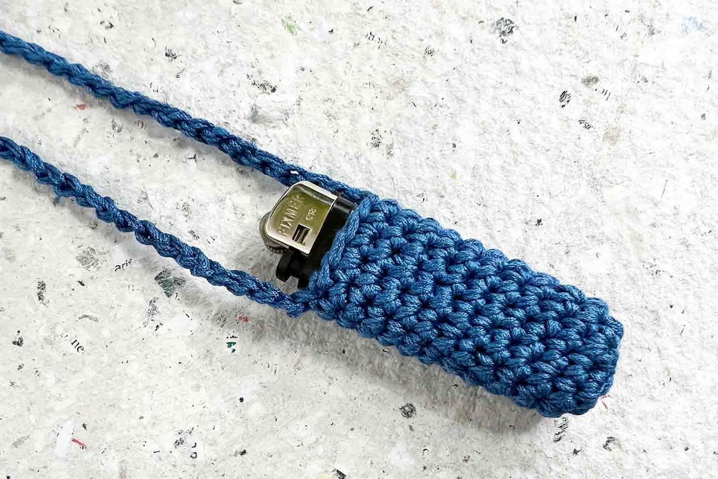 Ein gehäkelter blauer Lippenstift- oder Feuerzeughalter zum Umhängen SVETA, Festival Gadget