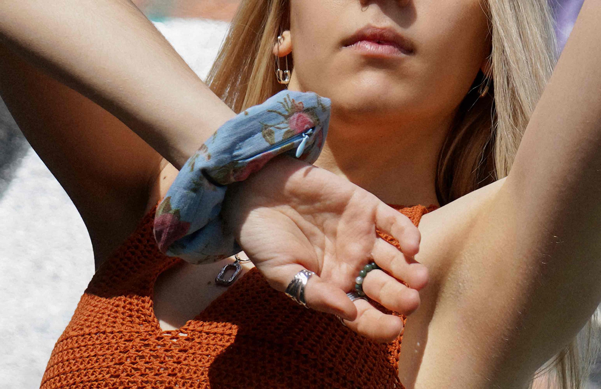 Frau trägt Scrunchie TRULLA als Haarband oder Haargummi mit verstecktem Reissverschlussfach aus Jeans Upcyling um Handgelenk